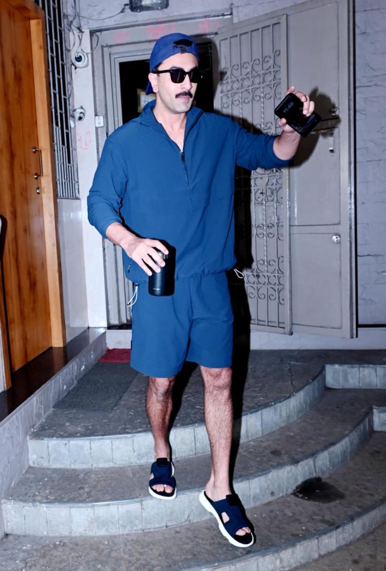 Ranbir Kapoor was seen exiting a dubbing studio in a blue casual shorts set, paired with a matching cap and sunglasses.